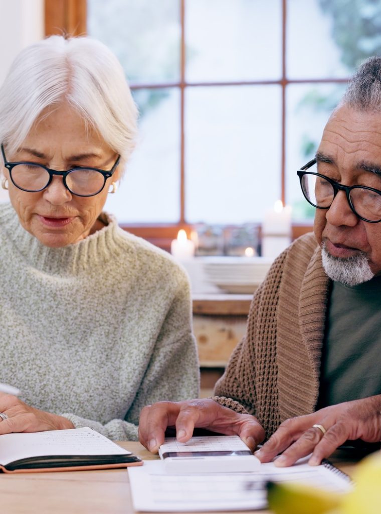 senior-couple-paperwork-and-contract-with-signature-and-life-insurance-information-for-will-and-po senior-couple-paperwork-and-contract-with-signature-and-life-insurance-information-for-will-and-po